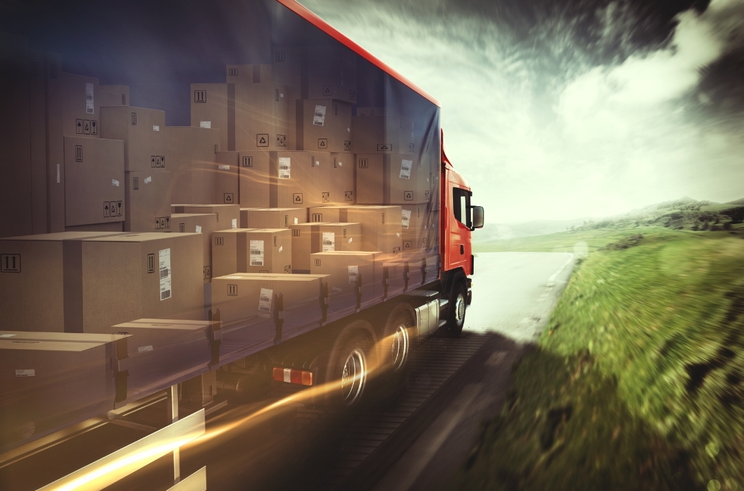 Semi truck loaded with freight boxes moving at speed along a highway
